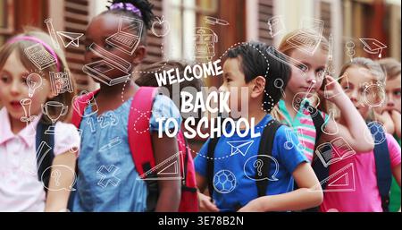 Posing kids chatting at school entrance, with backpacks, doodles and WELCOME BACK TO SCHOOL sign Stock Photo