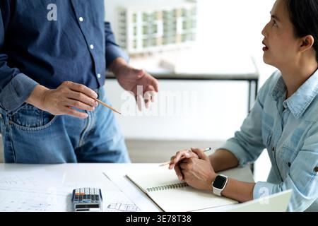 Architect or engineer are discussing and consulting in the office to find the best solution for the project and business organization. Stock Photo