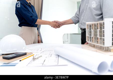 Architects or engineers hand shake to agree on the project and congratulate them on working together to make the project a success. Stock Photo