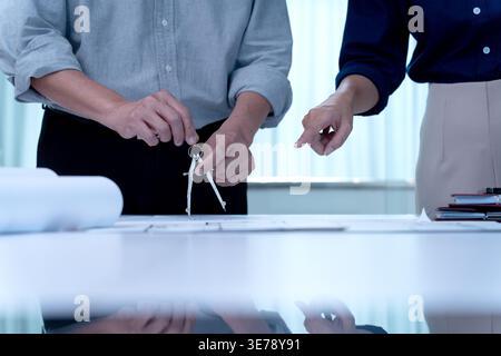 Architects or engineers are working together to design and revise the details of the plans according to the brainstrom idea. Stock Photo