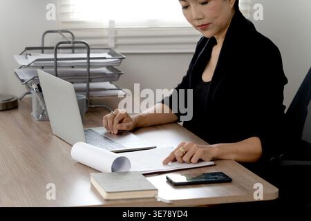 senior businesswoman is pressing the key board on a laptop. Computers are used for communication and as a convenience for doing business. Stock Photo