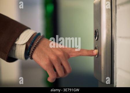 Adult Man Pressing Elevator Button in Office Building Entrance Stock Photo