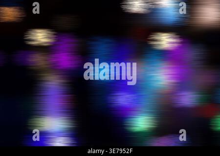 Colorful light streaks creating an abstract, dynamic blur on a dark background Stock Photo