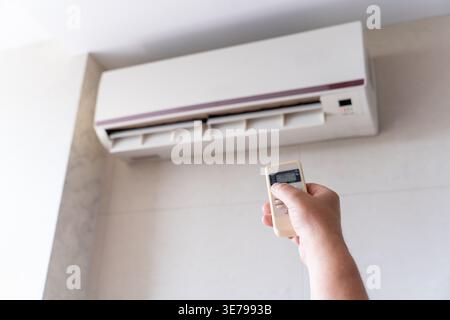 A male air conditioner technician or air conditioning installation. technician is about to repair air conditioning in homes and buildings. Smart Airfl Stock Photo