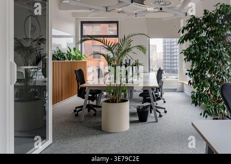 A modern office with multiple desks with monitors with a minimalist and professional atmosphere. Stock Photo