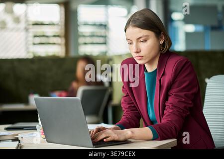 Adult Woman Working on Laptop in Office for Business Communication Stock Photo