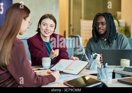 Diverse Business Team Collaborating during Office Strategy Meeting Stock Photo