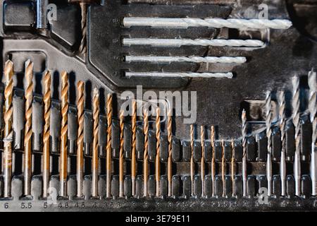 Set of drill bits and tools arranged in case showing different sizes and types for construction work, equipment collection Stock Photo