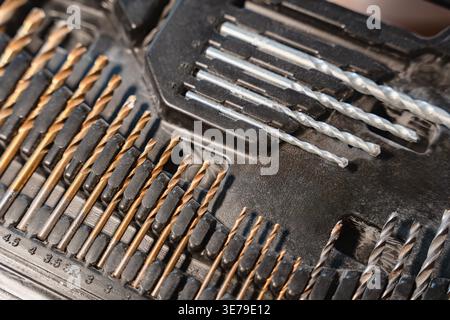 Close up view of drill bits in tool case showing metal texture and different sizes, construction tools, workshop equipment Stock Photo