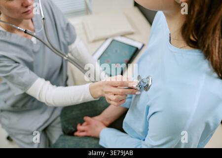 Female Doctor Examining Adult Woman during Preventive Checkup Stock Photo