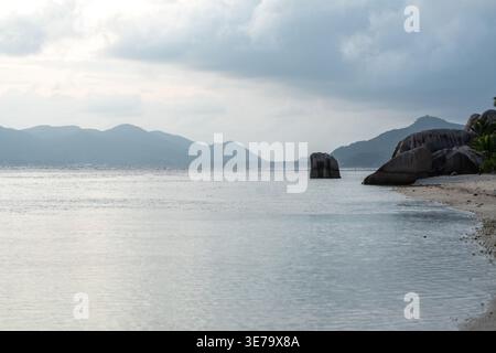 Anse Source d Argent beach at sunset with calm water granite boulders and no people on La Digue Island Seychelles Stock Photo