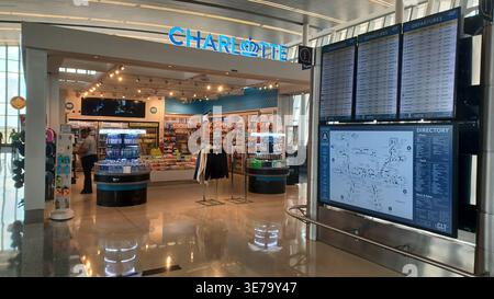 Charlotte, NC, USA - June 9, 2025: A busy view of Charlotte airport, with shops, flight boards, and terminal information, showcasing travel and conven Stock Photo