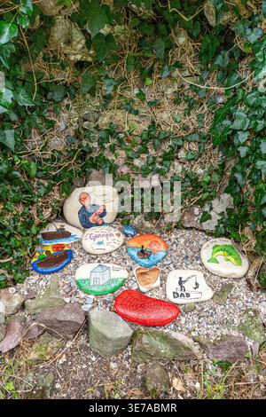 Hand painted memorial stones left in the ruins of Saint Columba's Chapel in the cemetery at Keil, Dunaverty Bay near Southend on the Kintyre Peninsula Stock Photo
