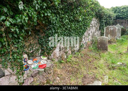 Hand painted memorial stones left in the ruins of Saint Columba's Chapel in the cemetery at Keil, Dunaverty Bay near Southend on the Kintyre Peninsula Stock Photo