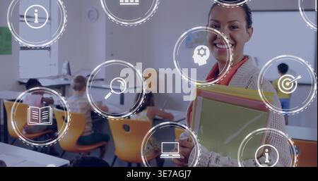 Smiling teacher wearing cardigan holding folders front-right classroom with UI icons, copy space Stock Photo