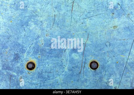 Abstract blue metal surface with scratches and bolts. Grunge industrial background. Stock Photo
