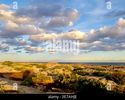 Evening Sunlight with Dramatic Multicolored Cloud Formation over Caribbean Sea Horizon, Akumal, Mayan Riviera, Mexico Stock Photo