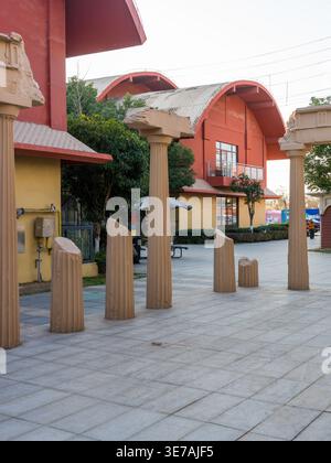Wuhan, Hubei, China - December 28, 2025: Artificial Roman-style stone pillar ruins installed on a paved public square. The decorative landscape featur Stock Photo