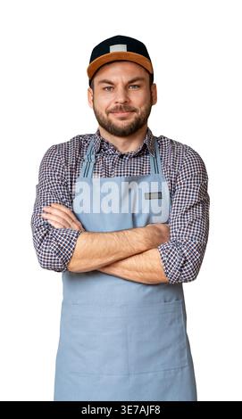 Portrait of adult male entrepreneur in apron and cap standing with crossed arms and looking and camera, isolated on white background. Stock Photo