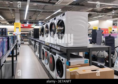 RUSSIA, Ufa - March 27, 2026: Tsentralnyy Trading Complex. Rows of household appliances and washing machines on shelves at an M.Video store. Stock Photo