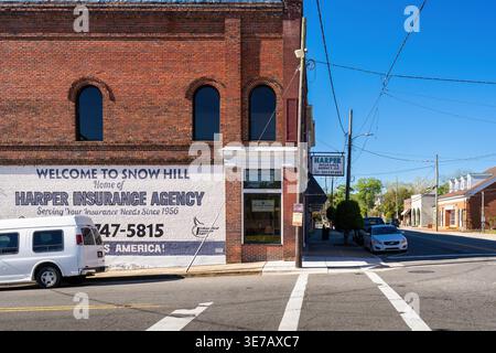 Snow Hill, North Carolina, USA – Exterior of Harper Insurance Agency with large painted mural and historic brick building in downtown Snow Hill. Stock Photo