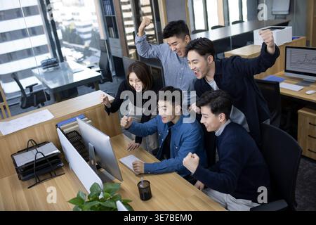 Chinese IT experts working together on computer in office Stock Photo