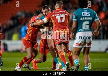 George Whitby of St Helens is tackled by Davy Litten of Hull FC during ...