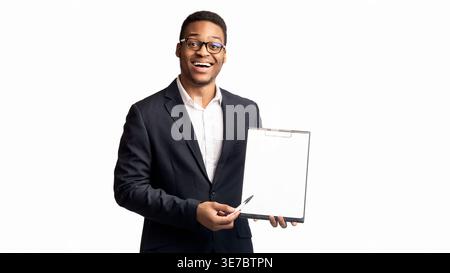 Black businessman with eyeglasses pointing pen on blank clipboard standing against white background Stock Photo