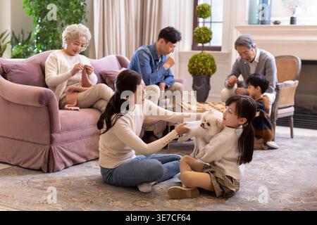 Chinese family spending time together in living room at home Stock Photo