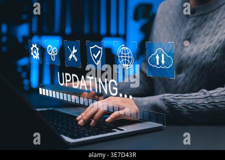 System Updating and Software Maintenance Concept. Woman using laptop with update progress bar, cloud, security system icons representing software Stock Photo