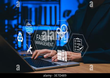 Facility Management Concept. professional using laptop and digital icons for AI automation, maintenance, security, sustainability, building operations Stock Photo