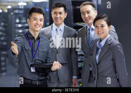 Chinese business team standing together in computer room Stock Photo