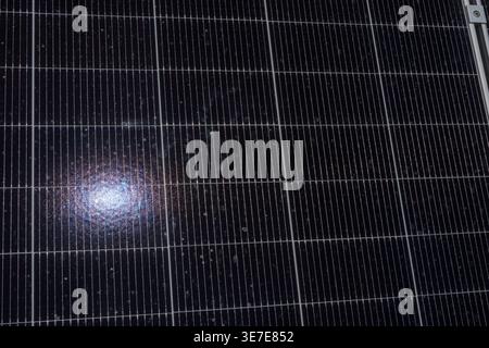 Abstract close-up of solar panel surface with sunlight reflection, forming a geometric pattern. Clean and modern renewable energy background ideal for Stock Photo