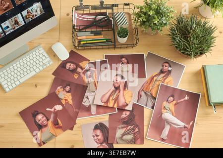 Photos of Black woman on wooden table with computer in office Stock Photo