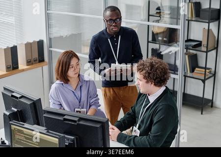 Diverse group of developers discussing new program working together in office Stock Photo