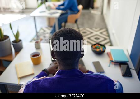 Black man working on laptop sitting at desk in office Stock Photo