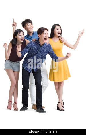 Surprised Chinese friends standing against white background in studio Stock Photo