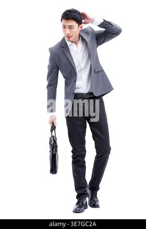 Chinese businessman holding bag scratching head standing against white background in studio Stock Photo