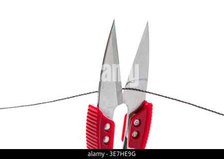 sewing scissors cutting thread on white isolated background Stock Photo