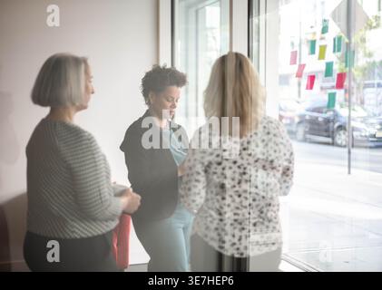 Black woman in a meeting with two white women Stock Photo