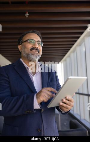 Confident businessman using tablet for business decisions Stock Photo