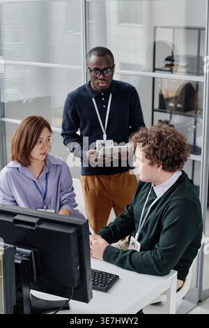 Diverse group of developers discussing new program working together in office Stock Photo