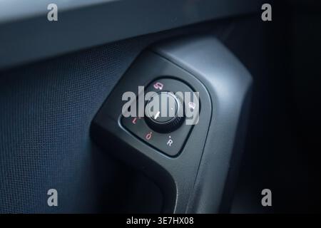 Car interior side mirror control knob in close up Stock Photo