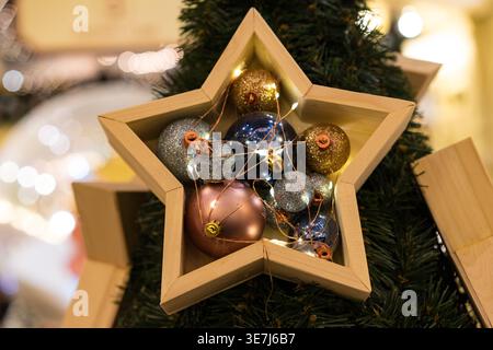Stunning star-shaped gift box adorned with vibrant red ornaments on a sleek black background, perfect for festive packaging and holiday promotions Stock Photo