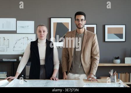 Serious diverse architects standing in working place at the office Stock Photo