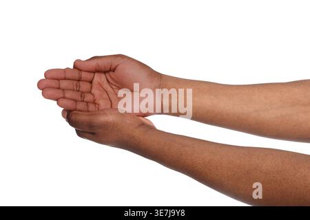 Hand of Black man keeping empty cupped palm against white background in studio Stock Photo