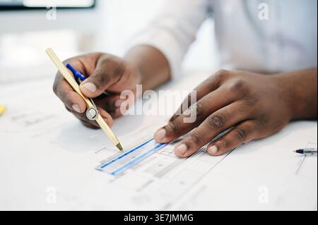 Compass, construction and drawing with hands of architect in office for building plans or development. Blueprints, measurement and pencil with man at Stock Photo