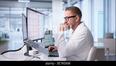 Doctor Battles Hospital Computer System Amid Busy Shift Stock Photo