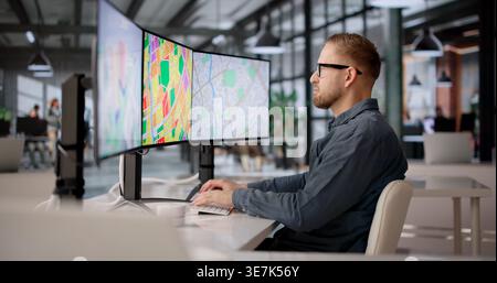 City Planner Analyzing Zoning Maps Across Multiple Screens For Urban Development Compliance Stock Photo