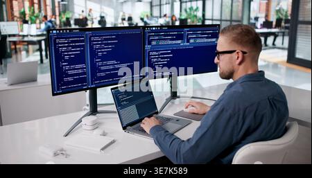 Focused Programmer Developing Innovative Software At His Workspace Stock Photo